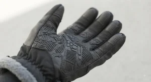 Close-up of textured rubber palms on waterproof winter work gloves under $40, showing enhanced grip for handling tools.
